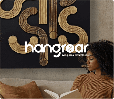 Curly-haired woman reading a book in front of a Hangroar wall decoration