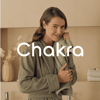 Warm image of a person in a green robe featuring the CHAKRA logo, highlighting a cozy, earthy ad template powered by AI advertising technology to boost conversions on Instagram reels, Facebook stories, and Google placements.