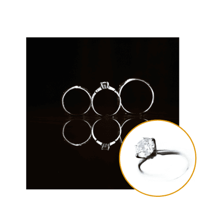 Elegant wedding rings displayed on a black background. The center ring showcases a dazzling diamond. AI creative ad catalog perfect for Shopify stores.