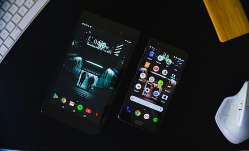 black android smartphone and tablet displaying home screen