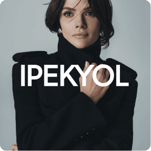 Studio portrait of a woman wearing a black high-neck coat, posing confidently against a neutral background, with the IPEKYOL logo displayed in bold white text.