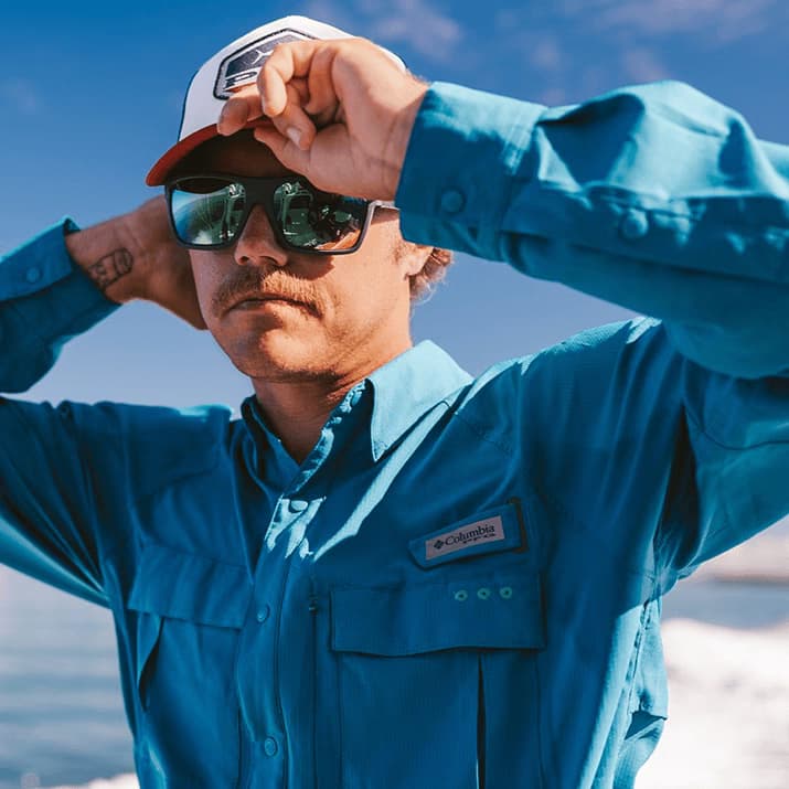 Dynamic image of a person in a black varsity jacket and light blue jeans against a vibrant blue and red background, showcasing a powerful AI-enhanced ad template that elevates apparel campaigns on Instagram reels, Facebook stories, and Google ads.